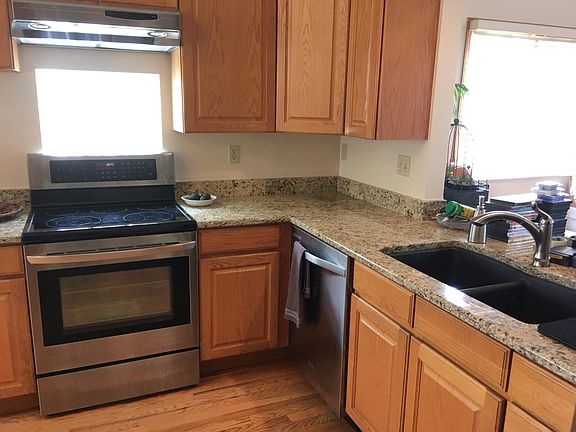 Kitchen has new stainless steel appliances and granite count