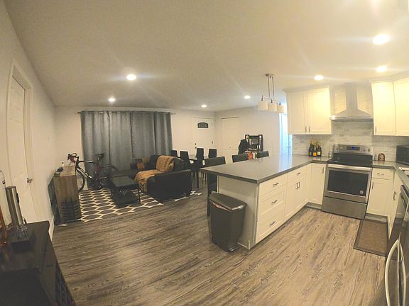 Different angle of open concept with countertop breakfast bar.