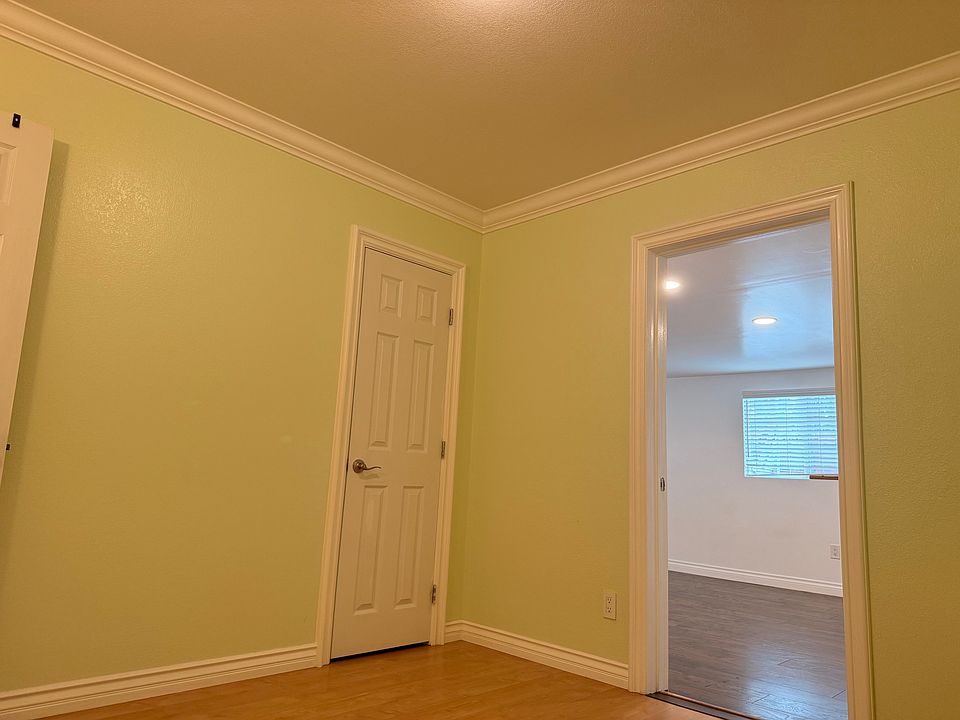 Bedroom with closet and laminate flooring.