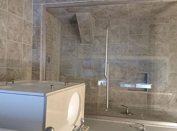 Master bath with custom ceramic tile oversized shower and flooring. A very boutique feel in this bathroom. You won't want to leave!