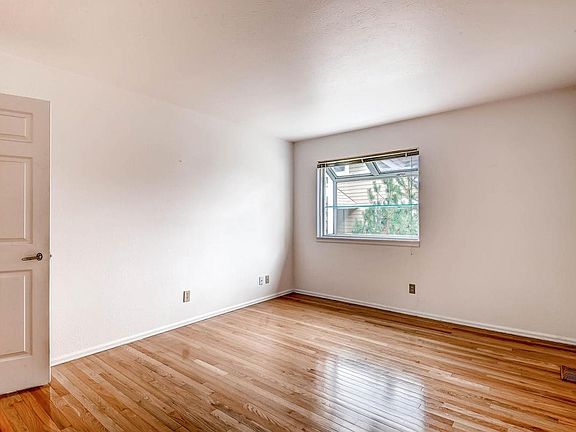 Main floor bedroom with garden window with shelves for plants.
