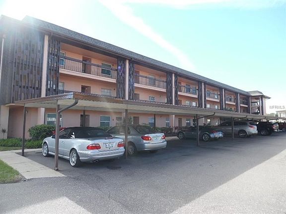 Condo building with carport directly in front of condo