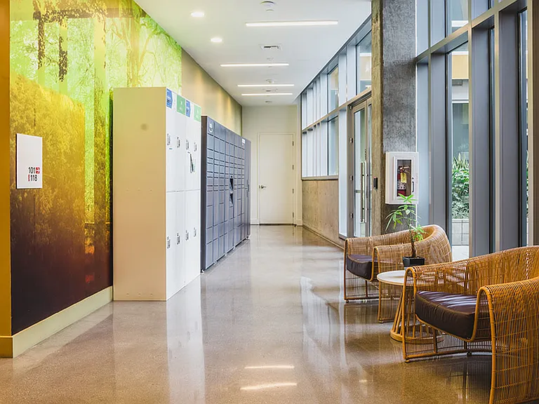 Mail room with floor to ceiling windows and package lockers