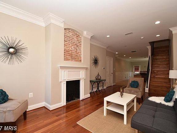 Spacious living room has so much charm with this decorative historic fireplace!