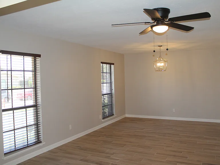 A spacious, versatile room just off the entry, perfect for a formal dining or living area with entry to the kitchen