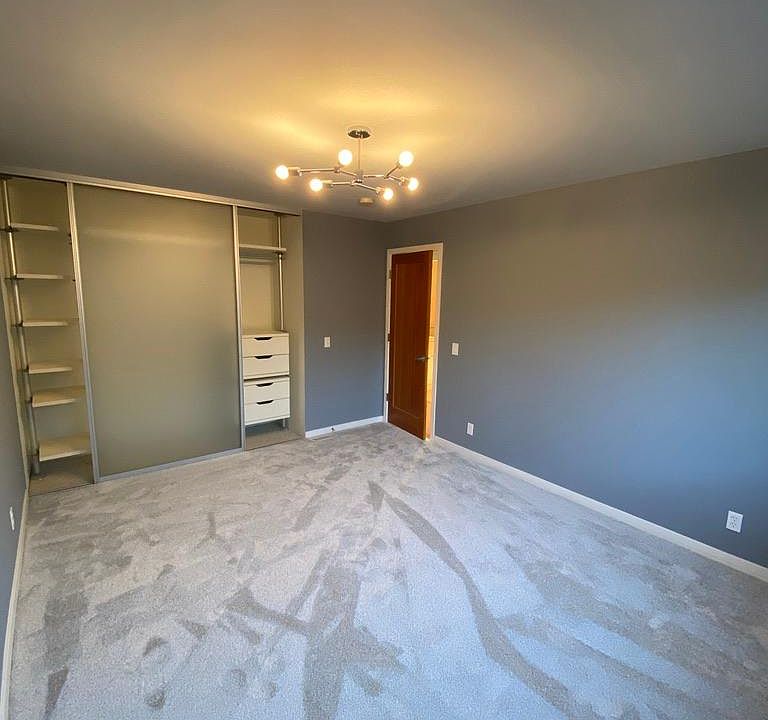 Newly remodeled master bedroom with closet organizer , new light fixture, and new carpet
