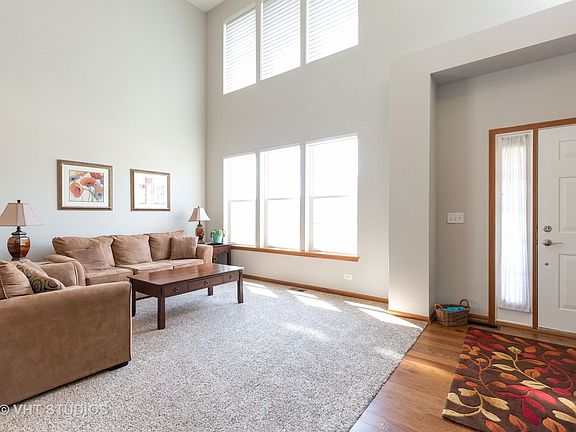 Stacked windows with remote control blinds provide natural light.