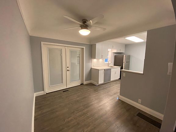 Open Kitchen and Dining Room with French Door to Outdoor Living Space