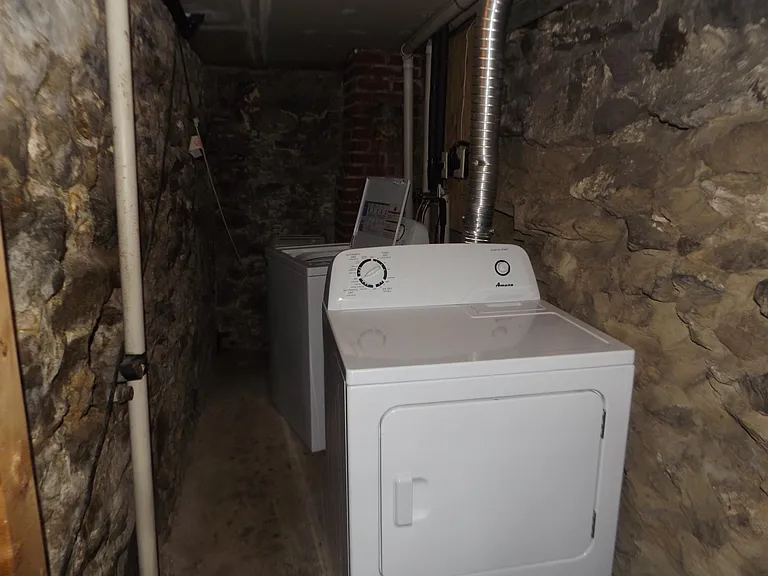 Full size washer and dryer and storage area