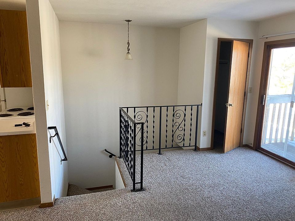 Interior entrance to apartment living room, coat closet, & patio door