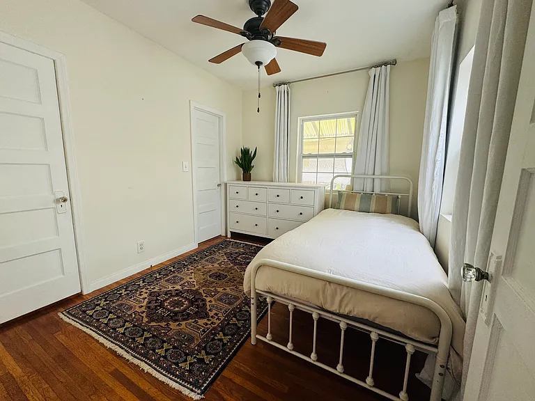 2nd bedroom. Ceiling fan, wall unit air conditioning/heat. Access to Jack and Jill bathroom.