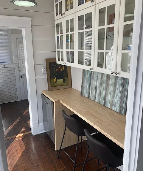 Multi-purpose, part of kitchen, eating area, and computer work area.