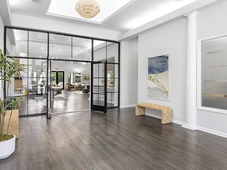 Bright lobby with glass entry doors and hardwood floors to welcome your guests