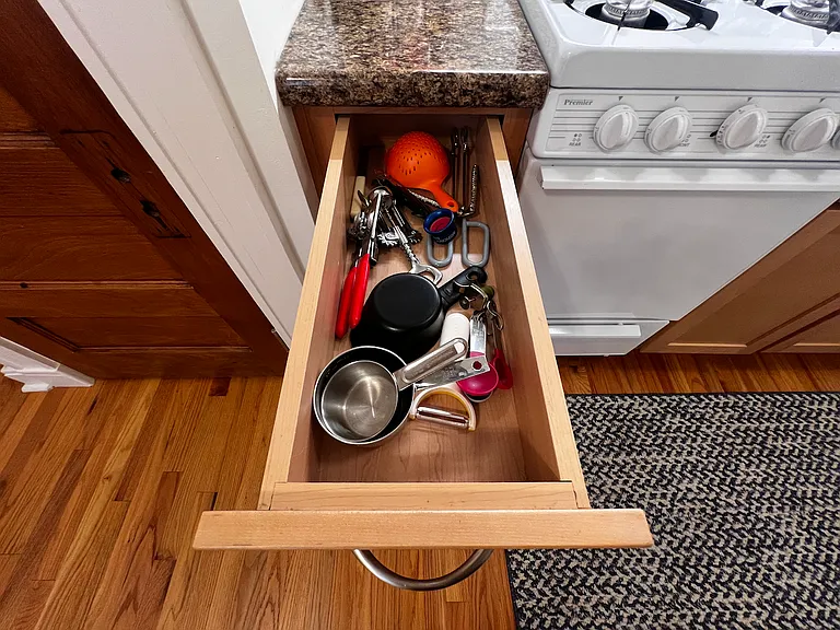 Cooking supplies in drawer.
