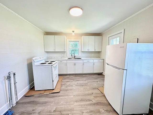Kitchen with Oven, Fridge. Stackable LG Washer/Dryer has been added since photo taken. Floors were just finished hence the appliances on moveable surfaces when photo was taken.