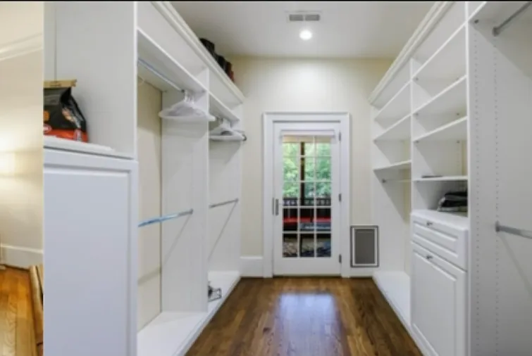 Main bedroom walk in closet with door leading to screened in back porch
