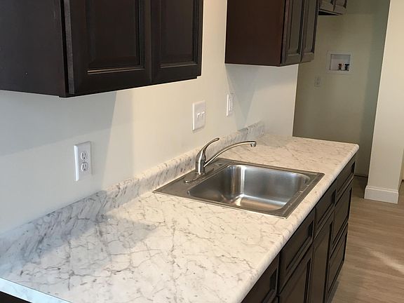 Large kitchen counter, stainless steel sink and faucet, slow closing cabinets and drawers