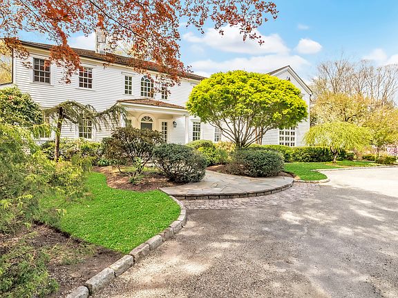 Elegant specimen plantings invite exploration of this lush, verdant property