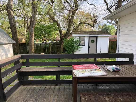 Back deck and yard (photo taken from kitchen window). The small shed shown (with wreath) is included in the rental and. isa great place to store additional items.