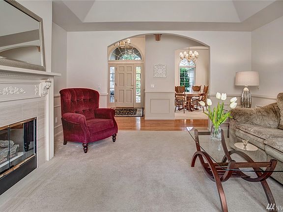 Exquisitely detailed formal Living room looking back to the front entry and formal Dining room.