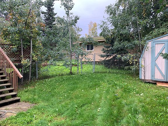 View from north entry gate towards manroom/she-shed, and tool shed
