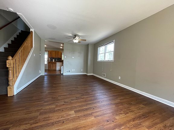 View of open concept living and dining area from the front including entry into kitchen area