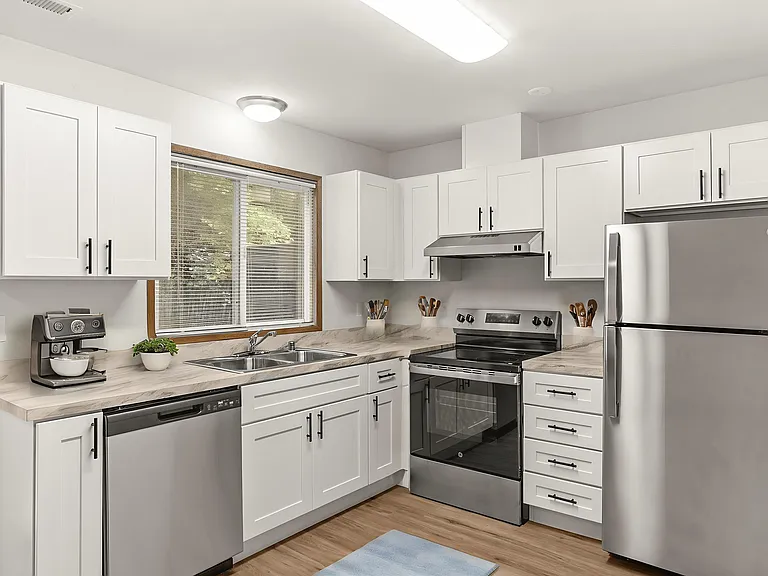 Bright and modern kitchen, virtually staged to highlight stainless-steel appliances, white cabinetry, and stylish marble-style countertops. Bright and modern kitchen, virtually staged to highlight stainless-steel appliances, white cabinetry, and stylish m