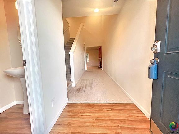 Home entrance and hallway, half bath on the left