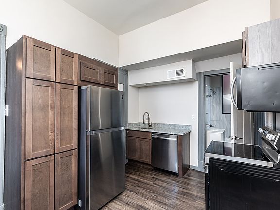 Nice wood cabinetry, granite counter tops and stainless appliances in this eat in kitchen.