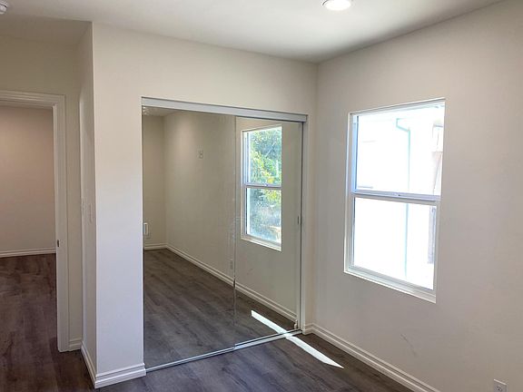 Bright bedroom with mirrored closet