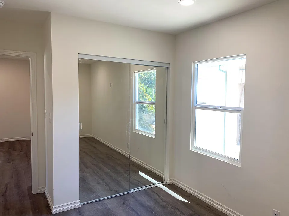 Bright bedroom with mirrored closet