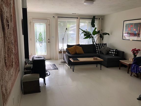 Living room looking towards front door. Newly installed and painted wood floors.