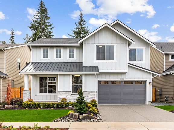 Masonry accents and rich landscaping