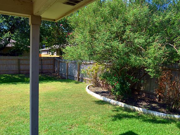 Large flower bed with gorgeous Texas Lilac & roses.