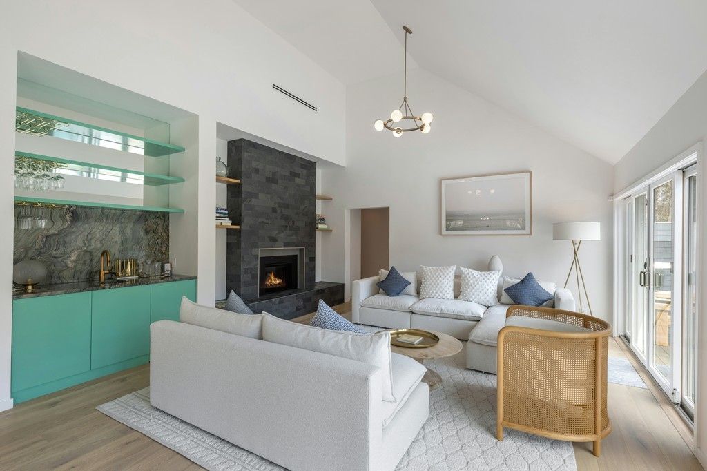 Open living with fireplace and wet bar