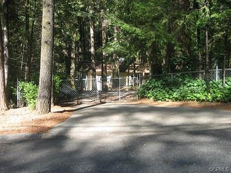 Gated  circular drive, fenced yard.