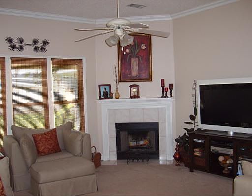 Open living area has wood cased windows, gas frplce, transom, wainscot, & more