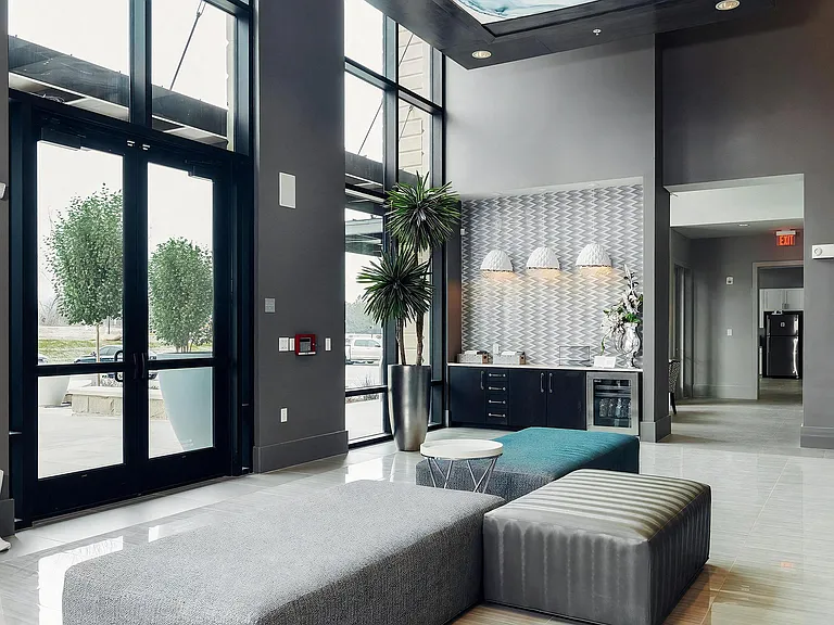 Modern Lobby with Coffee Bar, Patterned Wall Tile, and Lounge Seating