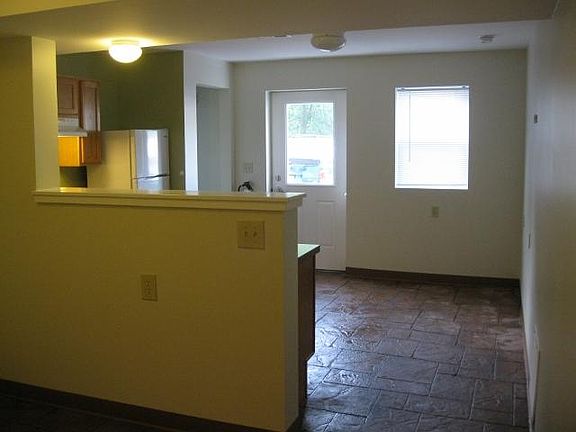 Looking towards the kitchen/living room and entrance from sleeping area.