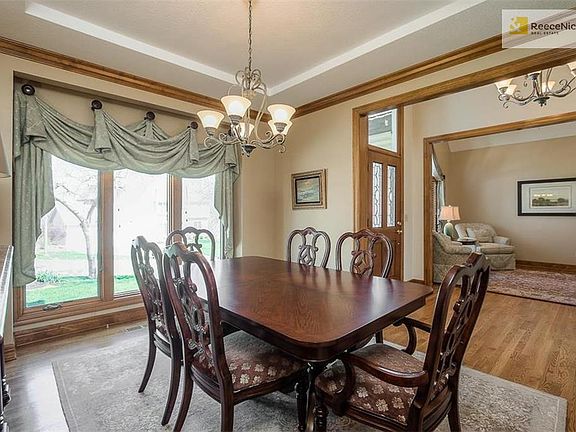 Formal dining with large windows make the space feel open and bright.