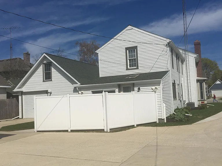 Back of home with private fenced yard.