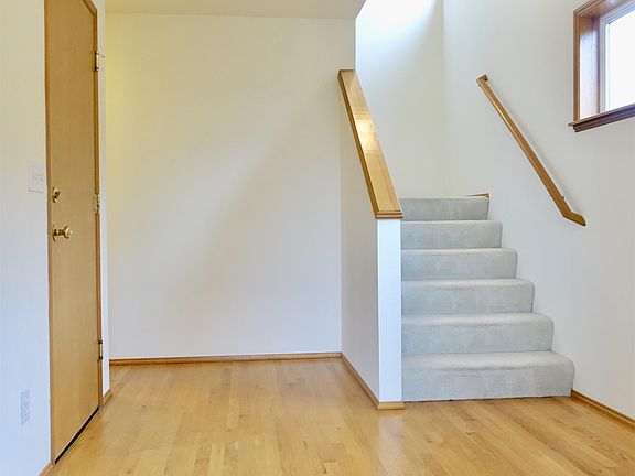 Large Welcoming Entrance with Hardwood Flooring