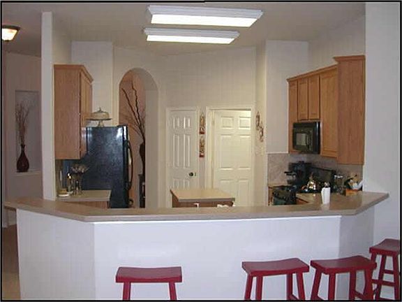  VIEW OF ISLAND KITCHEN W/BREAKFAST BAR FROM BREAKFAST ROOM.
