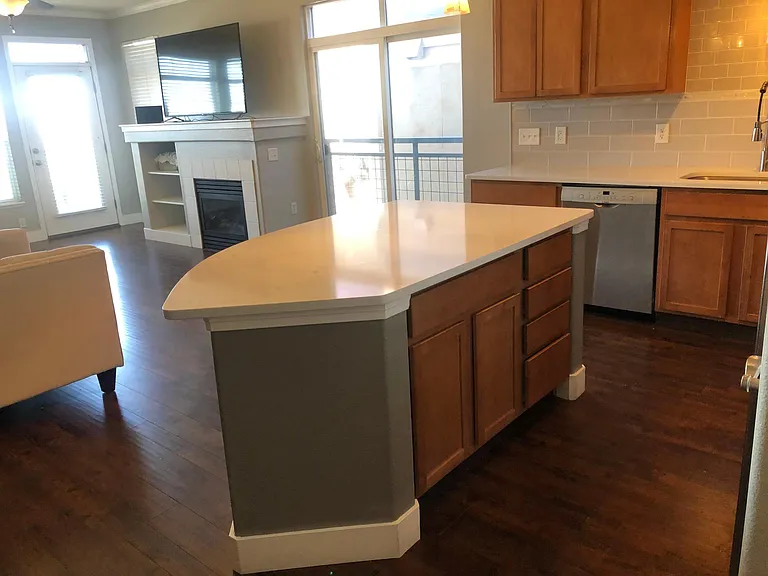 Spacious kitchen with large island provides comfortable food-preparation and entertaining space...with a view of the mountains! Also featured are the fireplace and a sliding glass door to one of three princess balconies