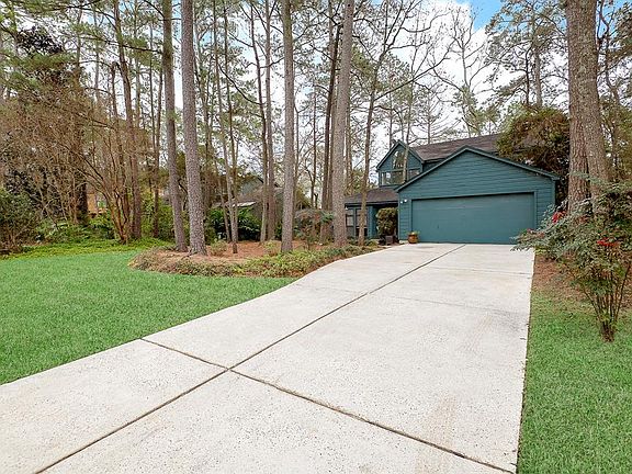 Long double driveway and nice natural landscaping.