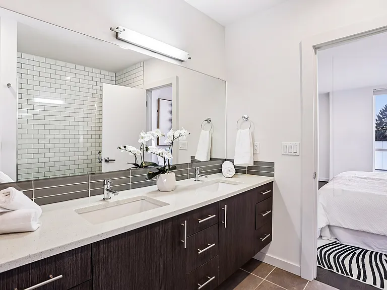 Upstairs bathroom with double vanity and walk-in shower.