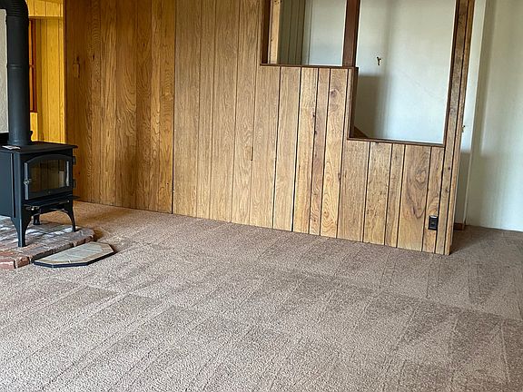 The staircase is closed off from upstairs.
Door past stove leads to kitchen/dining combo.