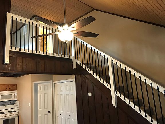 Staircase, leading to bathroom and bedroom.