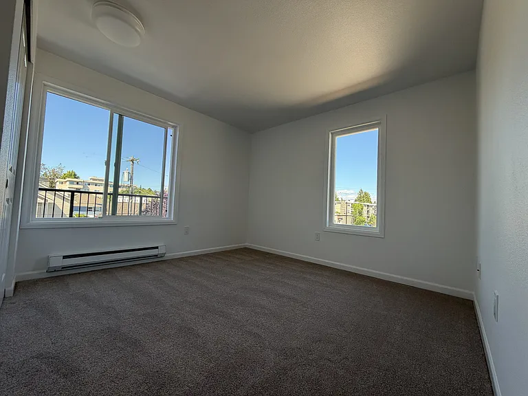 Bedroom 1, brand new carpet, light fixture, and thermostat