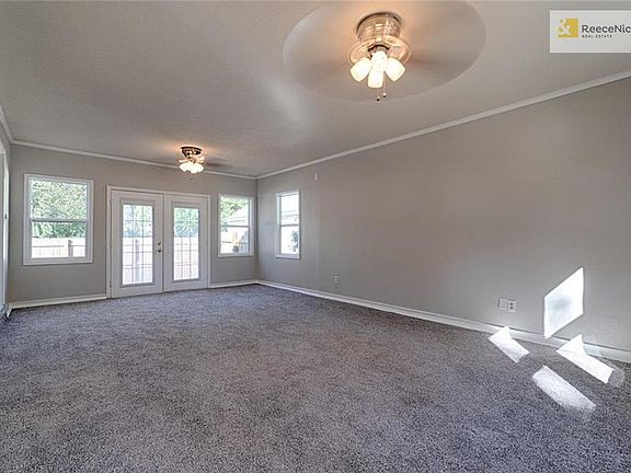Spacious family room with lots of light is located off the kitchen with french doors leading to the private patio.